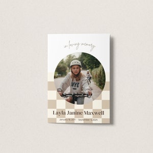 May include: In loving memory of Layla Janine Maxwell, January 18, 2011 - September 5, 2024. A black and white checkered background with a circle in the center. The circle contains a photo of a young girl wearing a helmet and riding a bicycle.
