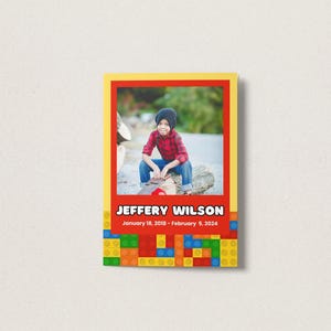 May include: A red, yellow, and blue Lego-themed card with a photo of a young boy wearing a plaid shirt and a blue hat. The card says "Jeffery Wilson" and "January 18, 2018 - February 5, 2024".
