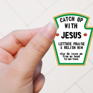 May include: A white sticker shaped like a ketchup bottle with the text "Catch Up With Jesus, Lettuce Praise & Relish Him *Cuz He loves me from my head to-ma-toes".