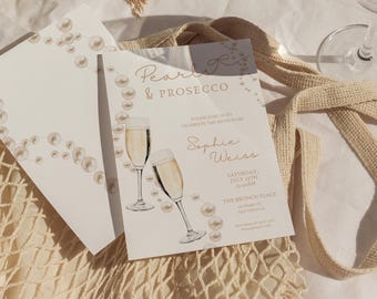 Puede incluir: Una tarjeta de invitación blanca con letras doradas que dice "Pearls & Prosecco" e invita a los invitados a celebrar a la futura novia, Sophie Weiss. La invitación incluye la fecha, la hora y el lugar del evento, que se celebra en The Brunch Place en Kam Daginga.