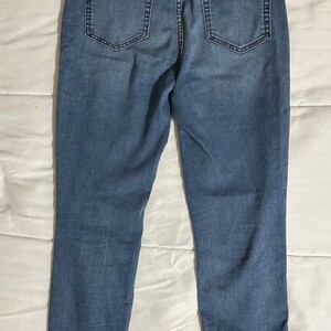 May include: A pair of blue denim jeans with a straight leg fit.