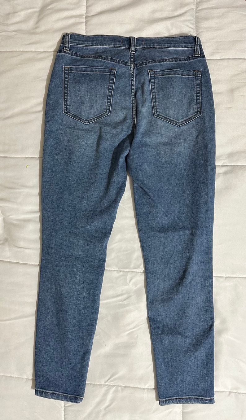 May include: A pair of blue denim jeans with a straight leg fit.