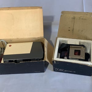 Vintage TMC Pocket Projector with TMC Model 1010 Filmstrip Adapter in Original Boxes.   Tested - works