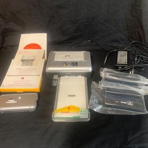 Kodak Easy Share Photo Printer Dock Model PH-160 w/manual.  Also includes 4 color ink cartridges and 11 packs of photo paper.  Tested works.