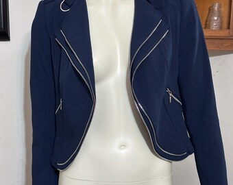 May include: A navy blue cropped moto jacket with silver zipper accents.