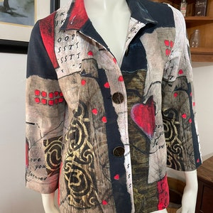 May include: A black, red, and gold patterned jacket with a heart design and the words "love you forever" on the sleeve.
