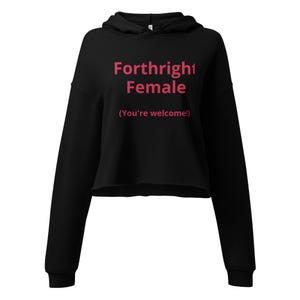 May include: Black cropped hoodie with the text "Forthright Female" in pink, with the phrase "(You're welcome!)" underneath. The hoodie has a drawstring hood and long sleeves.