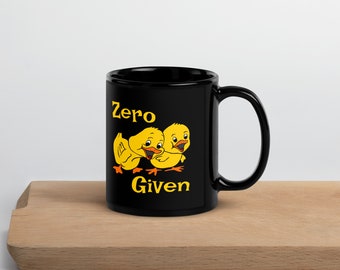 May include: Black coffee mug with a yellow cartoon image of two chicks and the text "zero given".