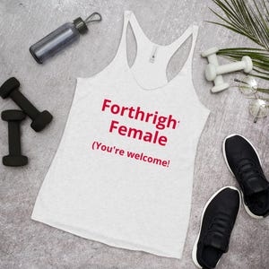 May include: White racerback tank top with the text "Forthright Female (You're welcome!)" in red. The image also includes black dumbbells, a water bottle, a pair of black sneakers, and small white dumbbells.
