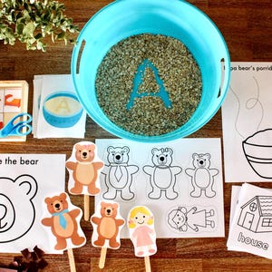 以下が含まれることがあります： 子供向けの「金髪の女の子と3匹のクマ」をテーマにした印刷可能なアクティビティのセット。セットには、クマの塗り絵、オートミールの入ったボウル、家、アルファベットのAが含まれています。アルファベットのAは、青いボウルに入れたオートミールで書かれています。