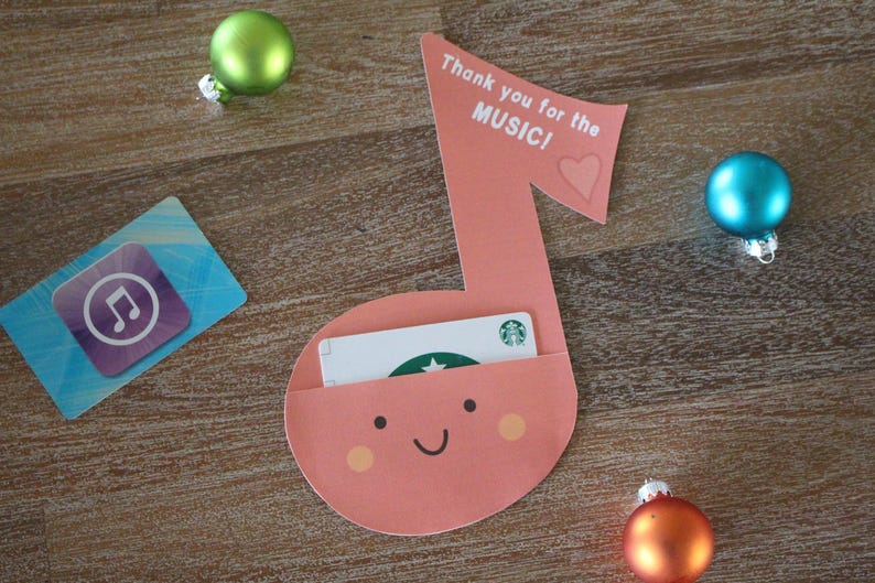 May include: A pink musical note shaped card with a pocket for a gift card. The card says "Thank you for the MUSIC!" with a heart. A gift card is visible in the pocket.