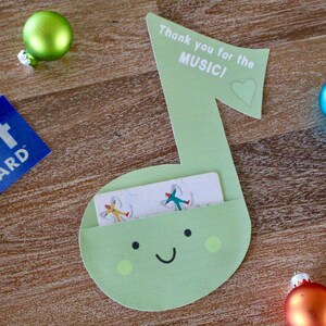 May include: A green paper music note with a gift card slot. The note has a smiley face and the text "Thank you for the MUSIC!" with a heart.