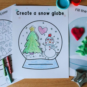 May include: A printable snow globe craft activity for kids. The activity includes a coloring page with a snowman, a Christmas tree, and a heart. The second page has instructions to "Fill the snow globe" with play dough.