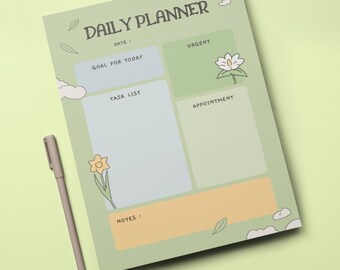 Puede incluir: Un planificador diario verde con un diseño floral. El planificador tiene secciones para objetivos, tareas, citas y notas.