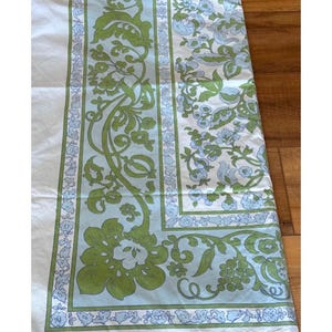 May include: A vintage floral patterned sheet featuring a white background with a green and light blue floral design. The sheet has a border with a repeating floral pattern and a central panel with larger floral motifs.
