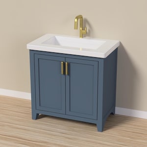 May include: A blue bathroom vanity cabinet with two doors and gold handles, topped with a white rectangular sink basin and a gold faucet. The unit features a clean, simple design with a recessed panel door style and four sturdy legs.
