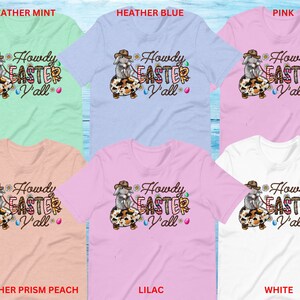 May include: Six different color t-shirts featuring a cartoon bunny holding an Easter egg with the text "Howdy Easter Y'all". The t-shirt colors are heather mint, heather blue, pink, heather prism peach, lilac, and white.