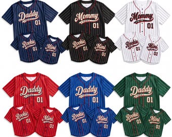 May include: A collection of short-sleeved button-down baseball jerseys in various colors including navy, black, white, red, blue, and green. Each shirt features vertical pinstripes and text reading Daddy, Mommy, Rookie, or Mini with the number 01.