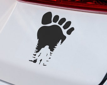 May include: Black vinyl sticker of a large footprint with a silhouette of a Bigfoot inside the footprint.