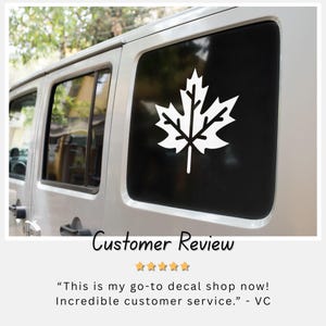 May include: White maple leaf decal on a black car window. The decal is a simple, clean design, perfect for car enthusiasts. The image also includes a customer review with five stars.