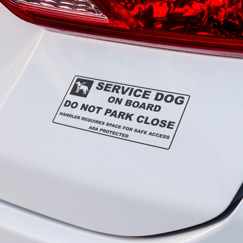 May include: A rectangular white sticker with black text and a graphic of a dog. The text reads "SERVICE DOG ON BOARD, DO NOT PARK CLOSE, HANDLER REQUIRES SPACE FOR SAFE ACCESS, ADA PROTECTED."