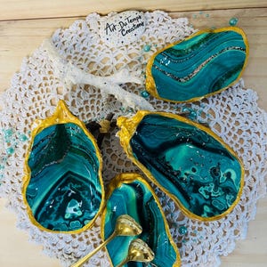 Salt and pepper shaker set with decorative oysters and small golden spoons