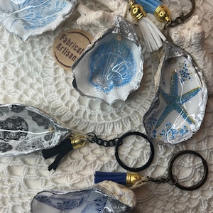 A handmade oyster shell key ring