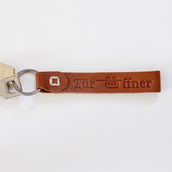 Schlüsselanhänger mit Schwebebahn / mit Prägung „Türöffner“ / Wuppertal / aus pflanzlich gegerbtem Leder / Schlüsselband
