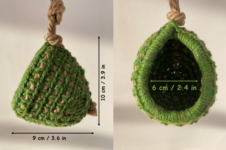 May include: A green and tan crocheted hanging pod with a jute rope hanger. The pod measures 3.9 inches in height and 3.6 inches in width, with a 2.4-inch wide opening. The structure is made of interwoven green and tan fibers in a textured pattern.