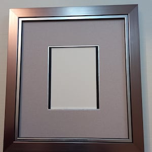 Frame with mat and coordinated easel back. Unique creation.