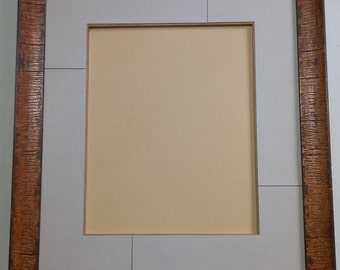 Frame with mat in 4 pieces.