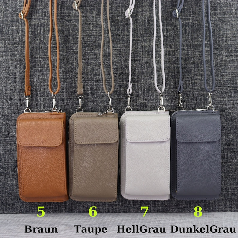 May include: Four leather phone pouches with adjustable straps in brown, taupe, light gray, and dark gray. The pouches are numbered 5 through 8 and labeled with the colors "Braun", "Taupe", "Hellgrau", and "Dunkelgrau".
