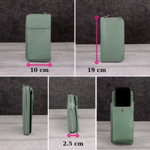 May include: A sage green leather wallet with a zipper closure. The wallet is 10 inches wide, 19 inches tall, and 2.5 inches thick.
