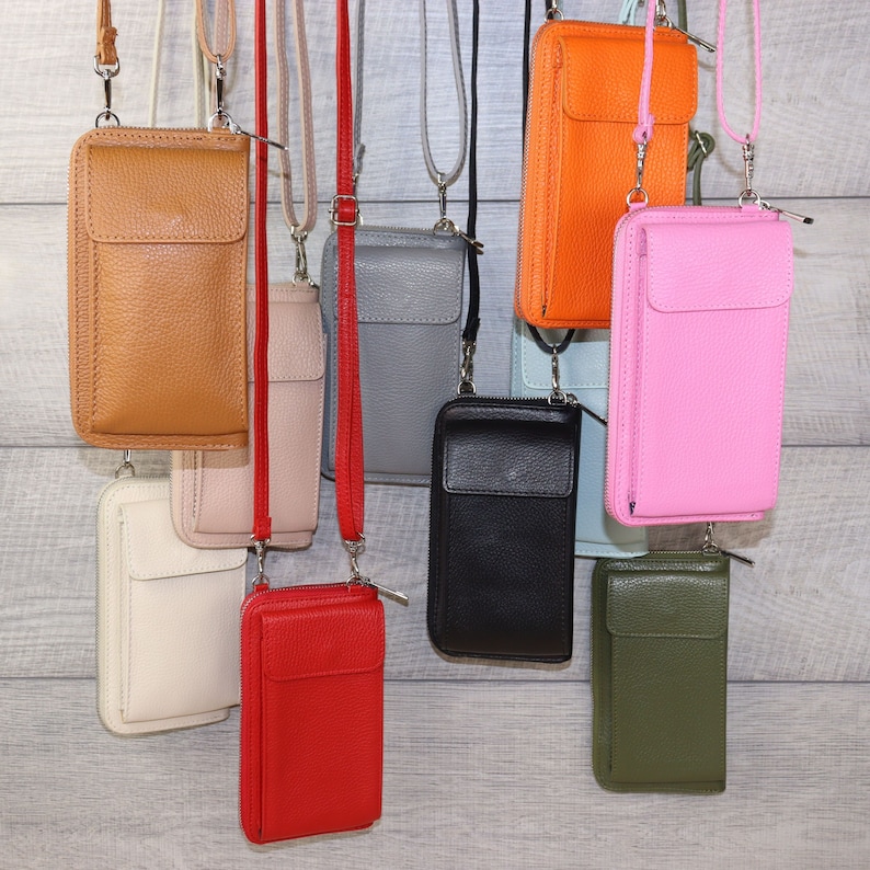 May include: Assortment of 10 leather phone cases with zipper closures and adjustable straps. The cases are in various colors, including black, red, pink, green, orange, brown, and gray.