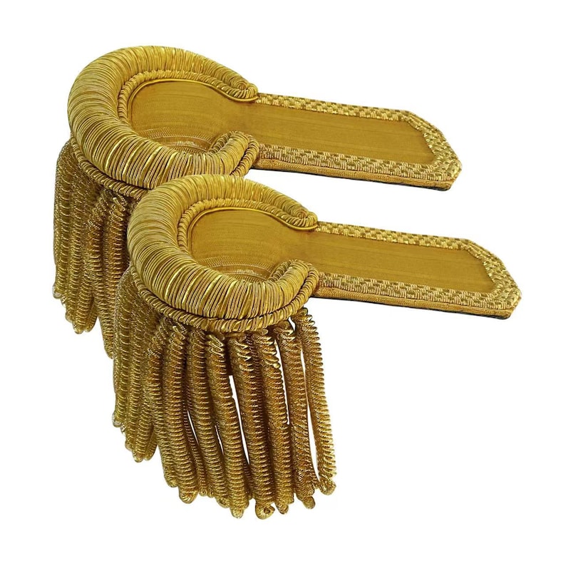 May include: Two gold-colored shoulder boards with fringed edges. The boards are made of a woven fabric and have a decorative pattern.