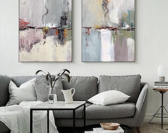May include: Two rectangular wall art canvases featuring abstract oil paintings with thick, textured brushstrokes in shades of gray, white, muted green, and accents of red and yellow, framed in thin black borders and displayed side by side.