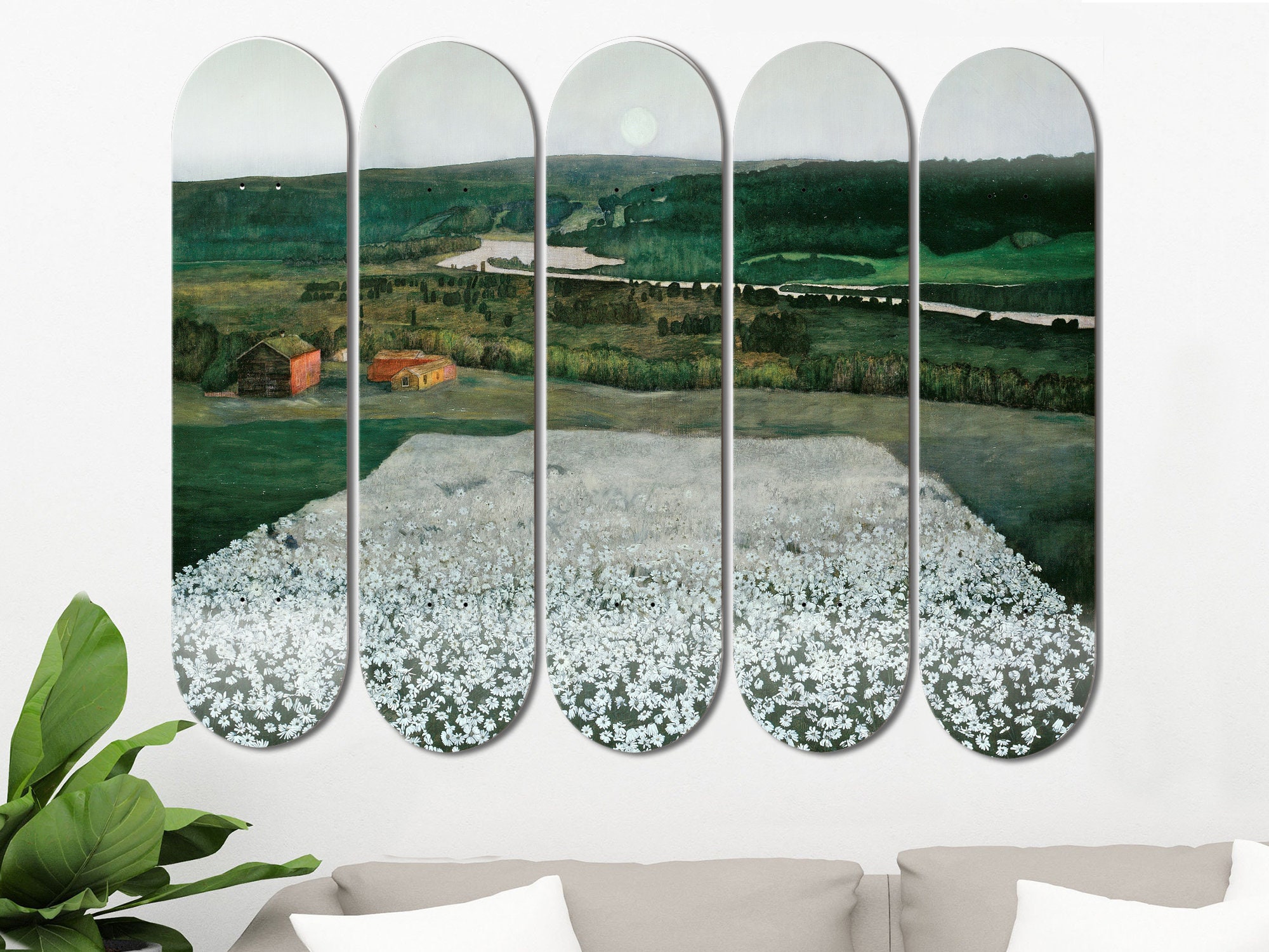 Multiple skateboard deck art pieces mounted horizontally on wall