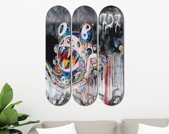 May include: Three skateboard decks with a colorful, abstract design featuring a cartoon monster with a large mouth and a yin-yang symbol. The decks are black with white paint splatters and the text "227" is written in white on the rightmost deck.