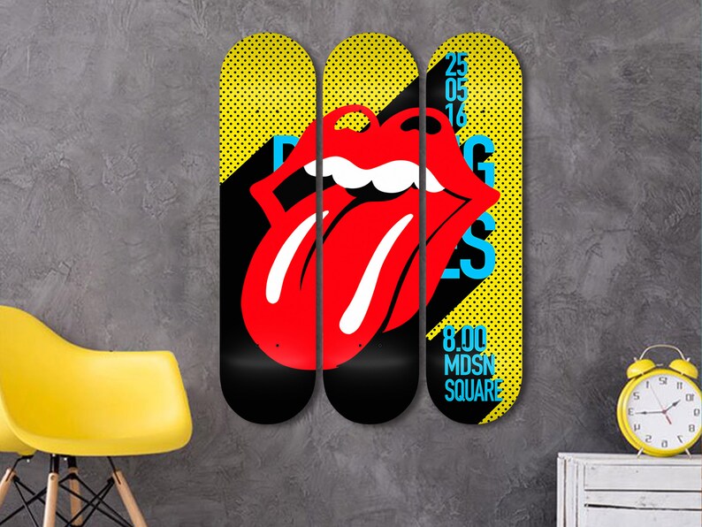 May include: Three yellow and black skateboard decks with a red tongue and lips graphic. The middle deck has the text "Rolling Stones" in blue and white. The right deck has the text "25 05 16" and "8.00 MDSN SQUARE" in blue and white.