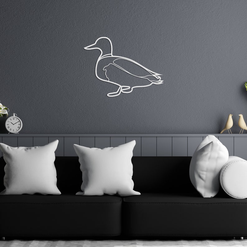 Rustic wooden flying duck sculptures on a light wall
