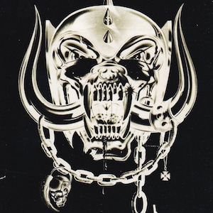 May include: Black and white image of a skull with horns and a chain. The skull is wearing a helmet and has a menacing expression. The text "Motörhead" and "England" are written in a bold, gothic font.