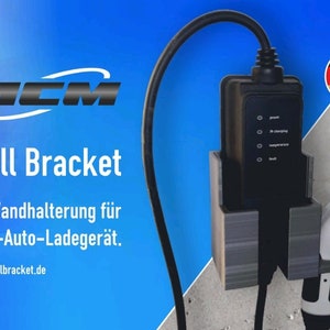 May include: A black wall mount for an electric vehicle charging station. The mount has a gray metal finish and is labeled "Wall Bracket". The text "Made in Germany" is visible in the upper right corner of the image.