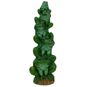 May include: A stack of four green ceramic frogs with gold eyes. The frogs are stacked on top of each other, with the largest frog at the bottom and the smallest frog at the top. The frogs are all facing forward, and their mouths are slightly open.
