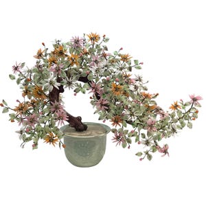 May include: A glass bonsai tree with pink, white and orange flowers in a green ceramic pot. The tree has a brown wooden trunk and green leaves.