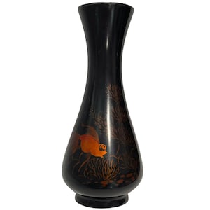 May include: A black vase with a tapered neck and a rounded base, featuring a painted design of an orange goldfish swimming among dark brown aquatic plants and coral-like structures on the lower portion of the exterior surface.
