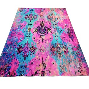 a vibrant, colorful rug with a floral pattern in shades of pink, blue, and purple.