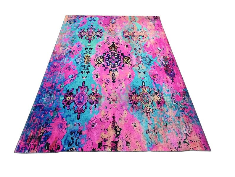 a vibrant, colorful rug with a floral pattern in shades of pink, blue, and purple.
