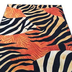 a vibrant and bold pattern of black and orange stripes, resembling the distinctive markings of a zebra.
