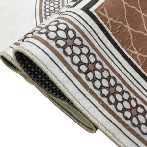 a close-up view of a decorative rug with a floral pattern.