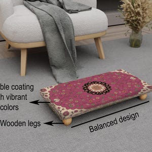 May include: A rectangular footstool with a vibrant pink floral pattern and wooden legs. The footstool has a durable coating and a balanced design. The text on the image says "Durable coating with vibrant colours" and "Wooden legs".